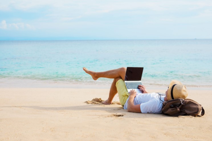Remote worker sits on beach